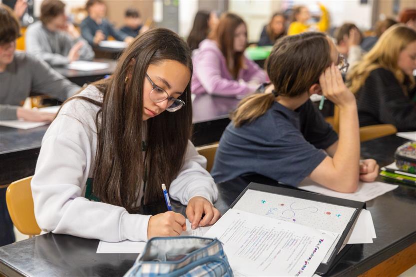 Students study rocks in a science lab